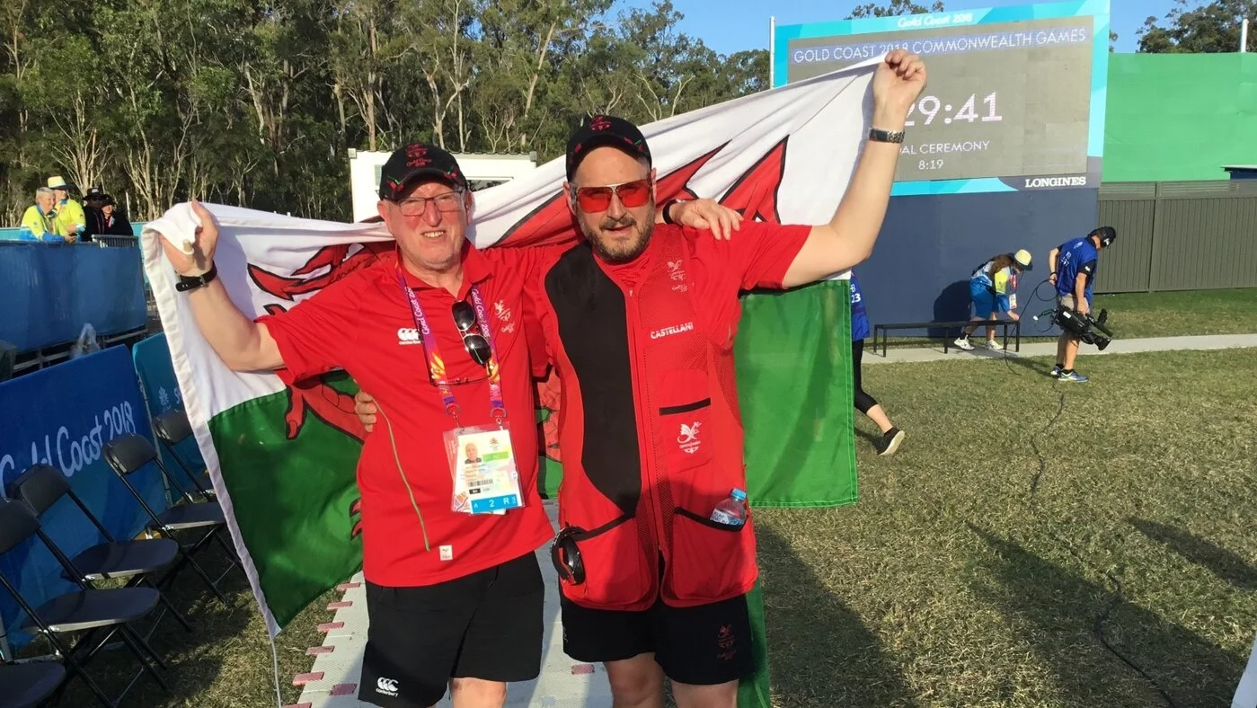 Mike Wixey celebrating with his coach and the Red Dragon