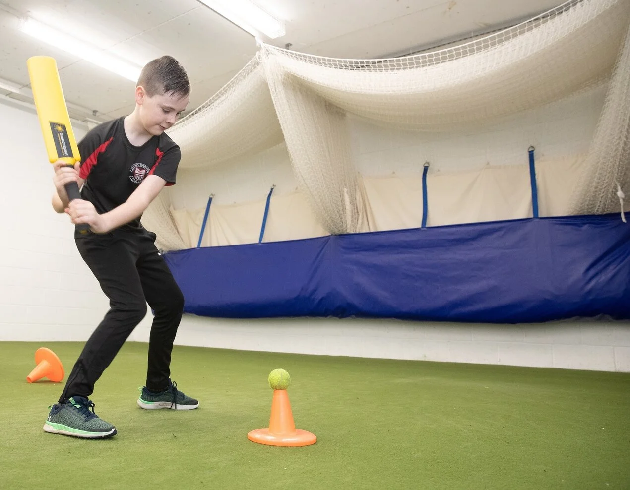 Boy playing cricket